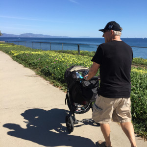 man pushing stroller in california 
